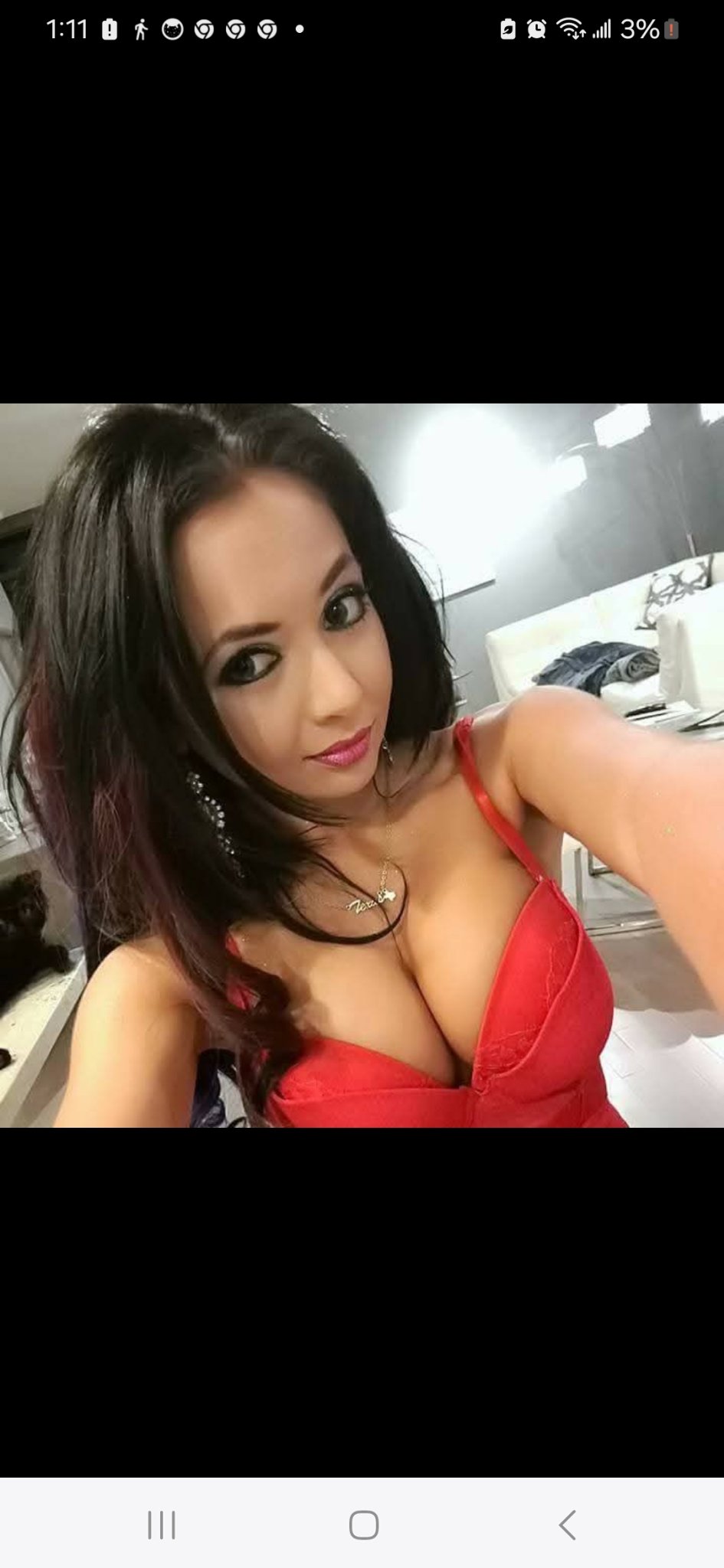 Jennifer Jorgensen Ahmed close-up selfie in a red dress with dark wavy hair